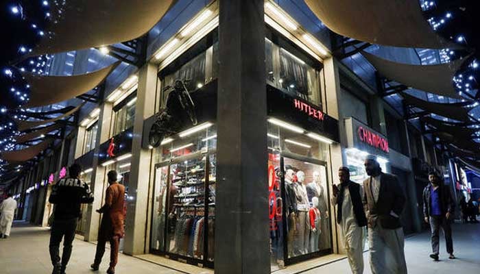 People walk outside shops at the shopping mall in Karachi, Pakistan, on January 3, 2023. — Reuters