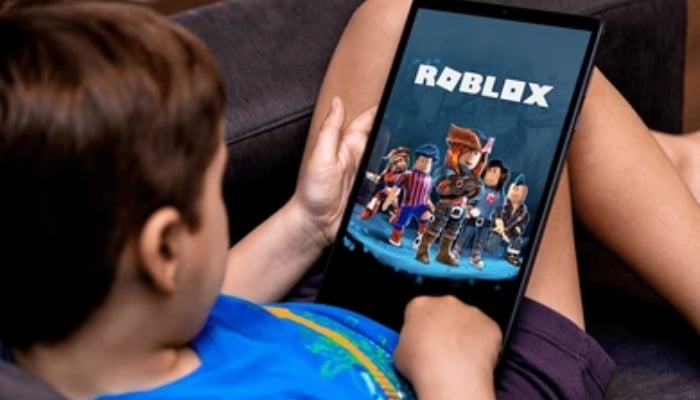 An undated image shows a kid using tab, on which Roblox is displayed. — Shutterstock