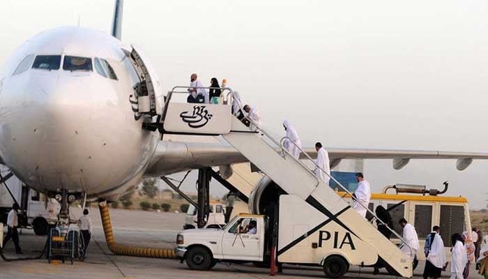 Hajj pilgrims board a Pakistan International Airlines aircraft to Makkah in Saudi Arabia, for the annual Hajj pilgrimage from Quetta International airport in Quetta on September 30, 2011. — AFP