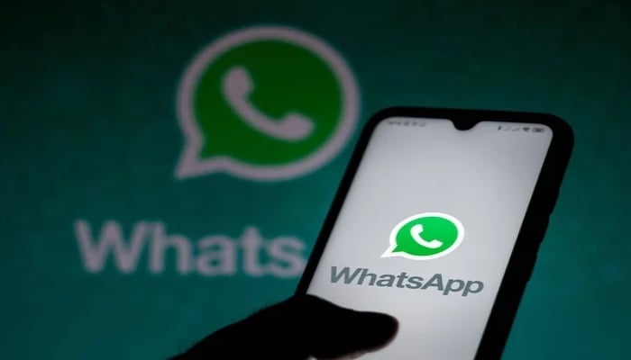 An undated image shows WhatsApp app on mobile phone and WhatsApp with its icon in the background. — Depositphotos
