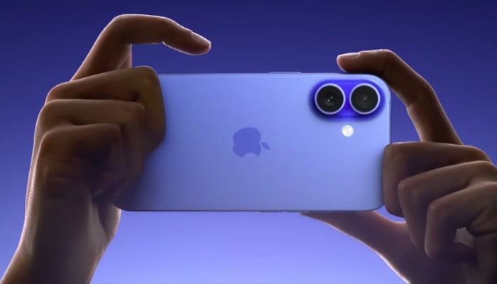 An undated image of a person using iPhone 16. — Apple