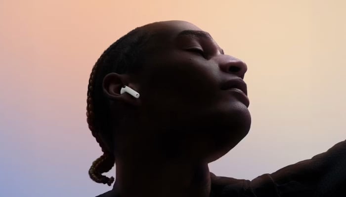 An undated image of a person using Apple AirPods 4. — Apple