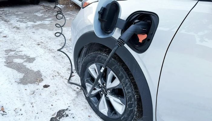An undated image of a car connected to an EV charger.