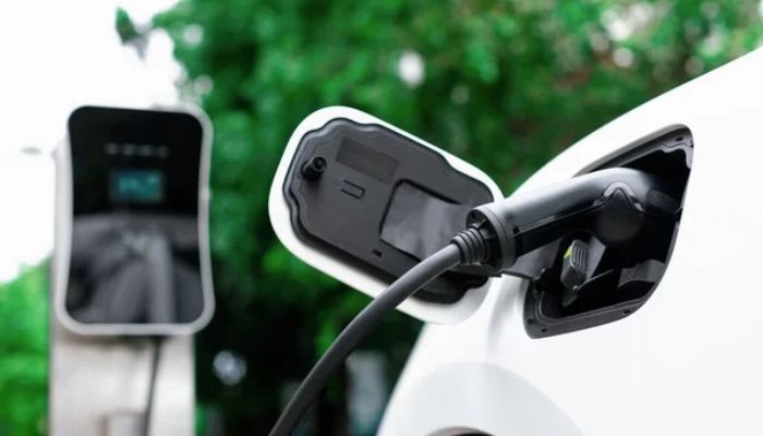 An undated image of an EV charger connected to a car. — DepositPhotos