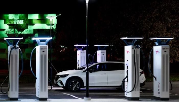 An undated image of a car connected to an EV charger. — QMerit