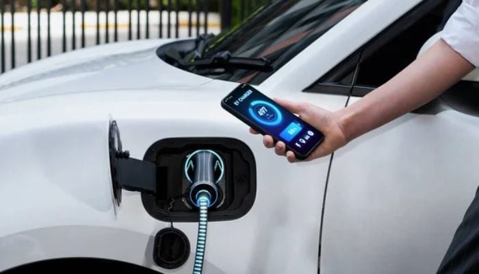 An undated image of an EV charger connected to a car. — DepositPhotos