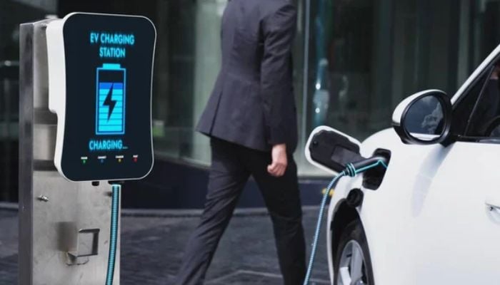 An undated image of an EV charger connected to a car. — DepositPhotos