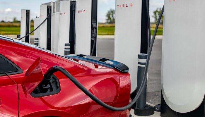 An undated image of a car connected to a Tesla EV charger. — Tesla