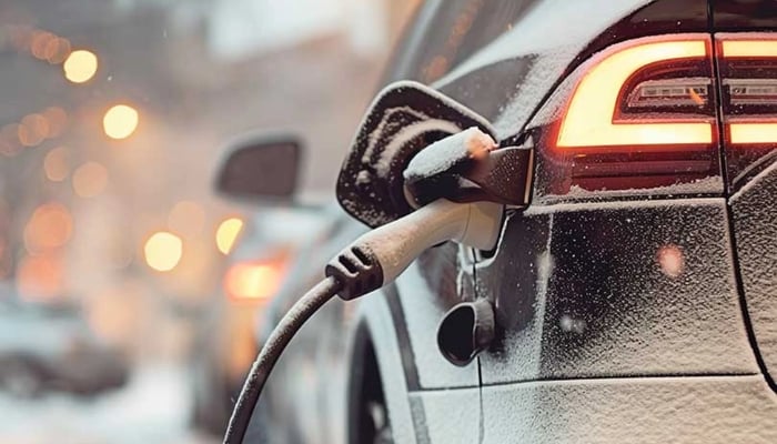 An undated image of an EV being charged in in snowy condition. — Vecteezy